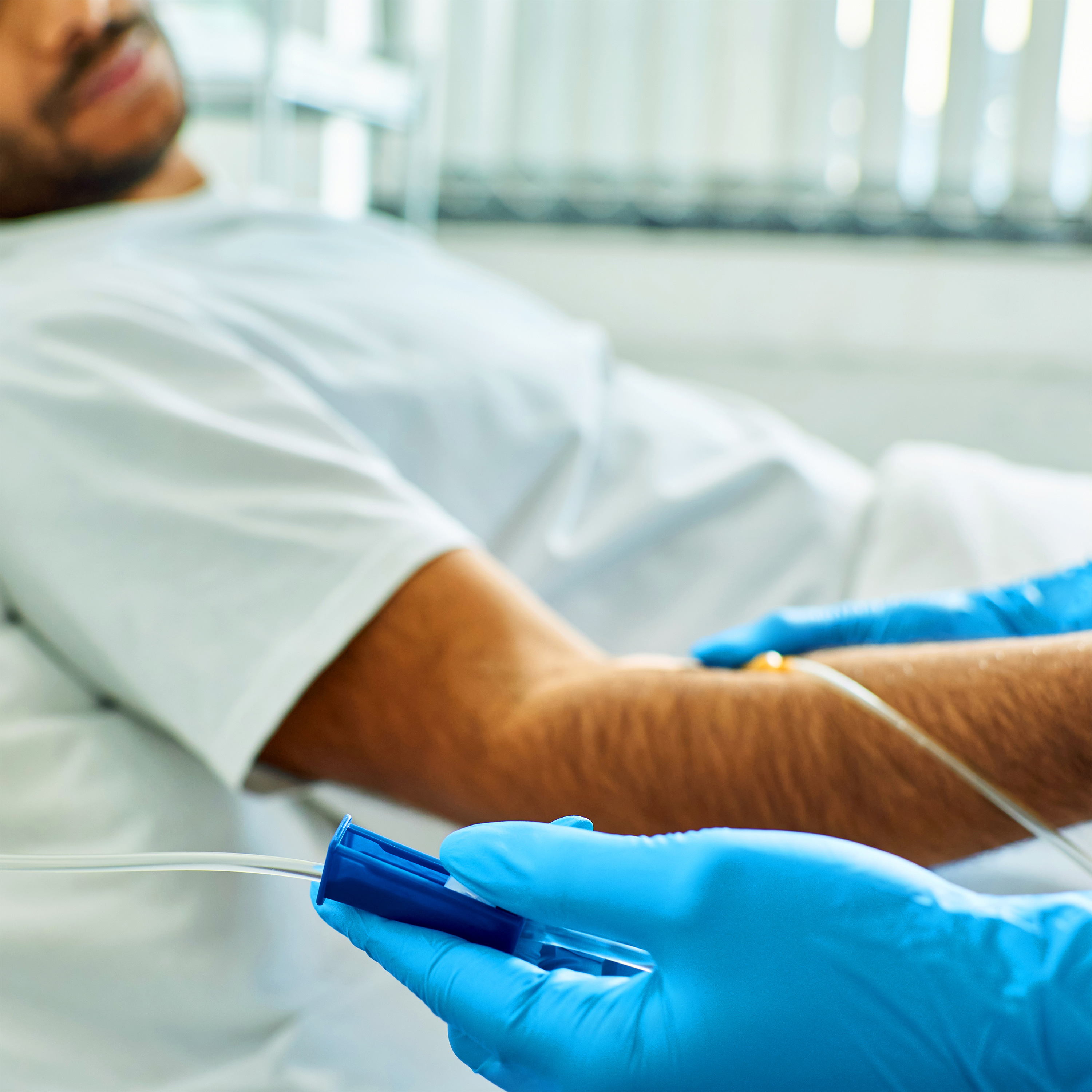Patient receiving infusion treatment in a clinical care setting
