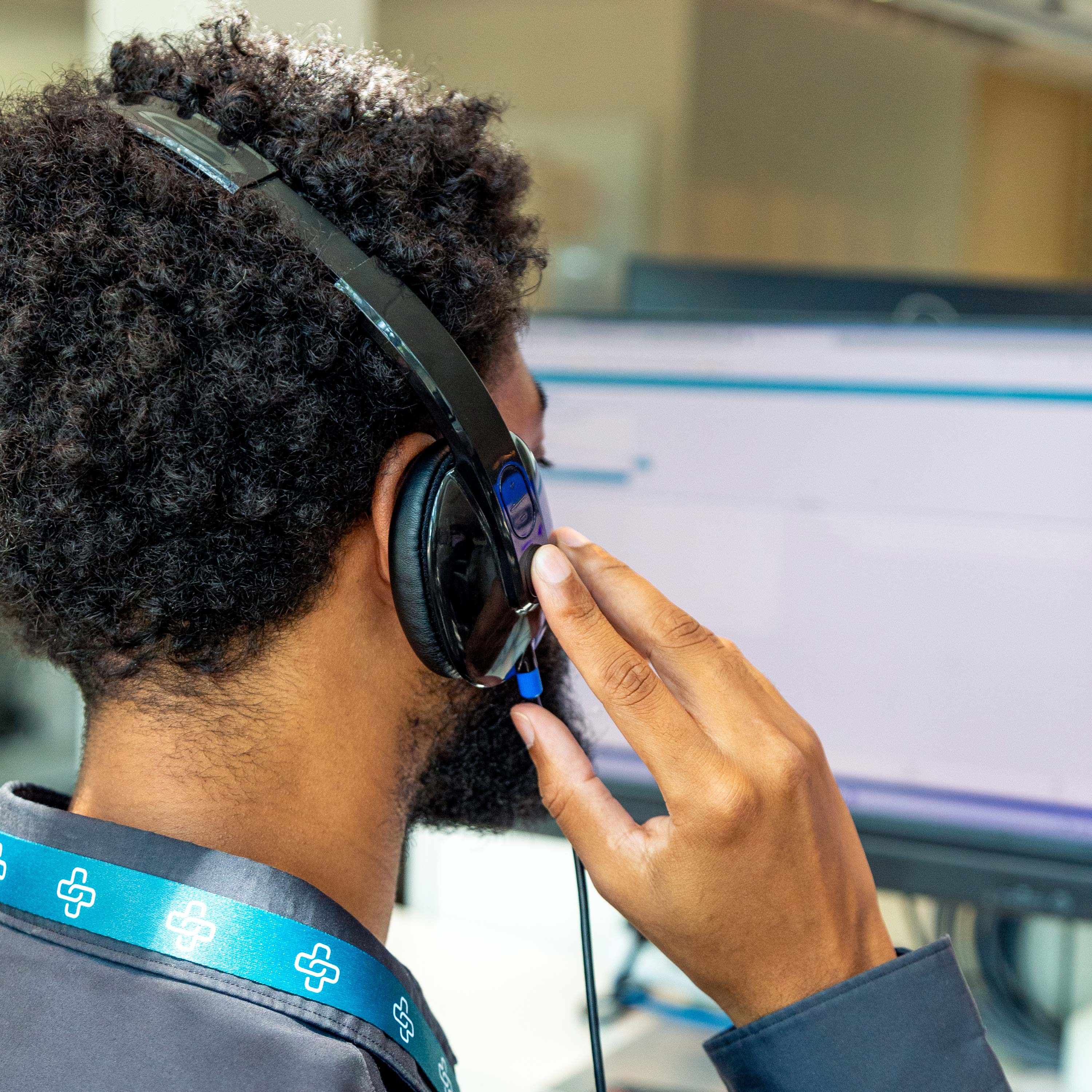 Case manager on headset in front of a computer